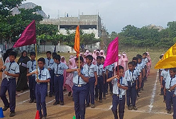 Students participating in school parade with flags